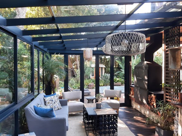 Lean-to conservatory with couch, chairs and lights