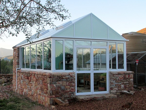 White greenhouse with natural stone